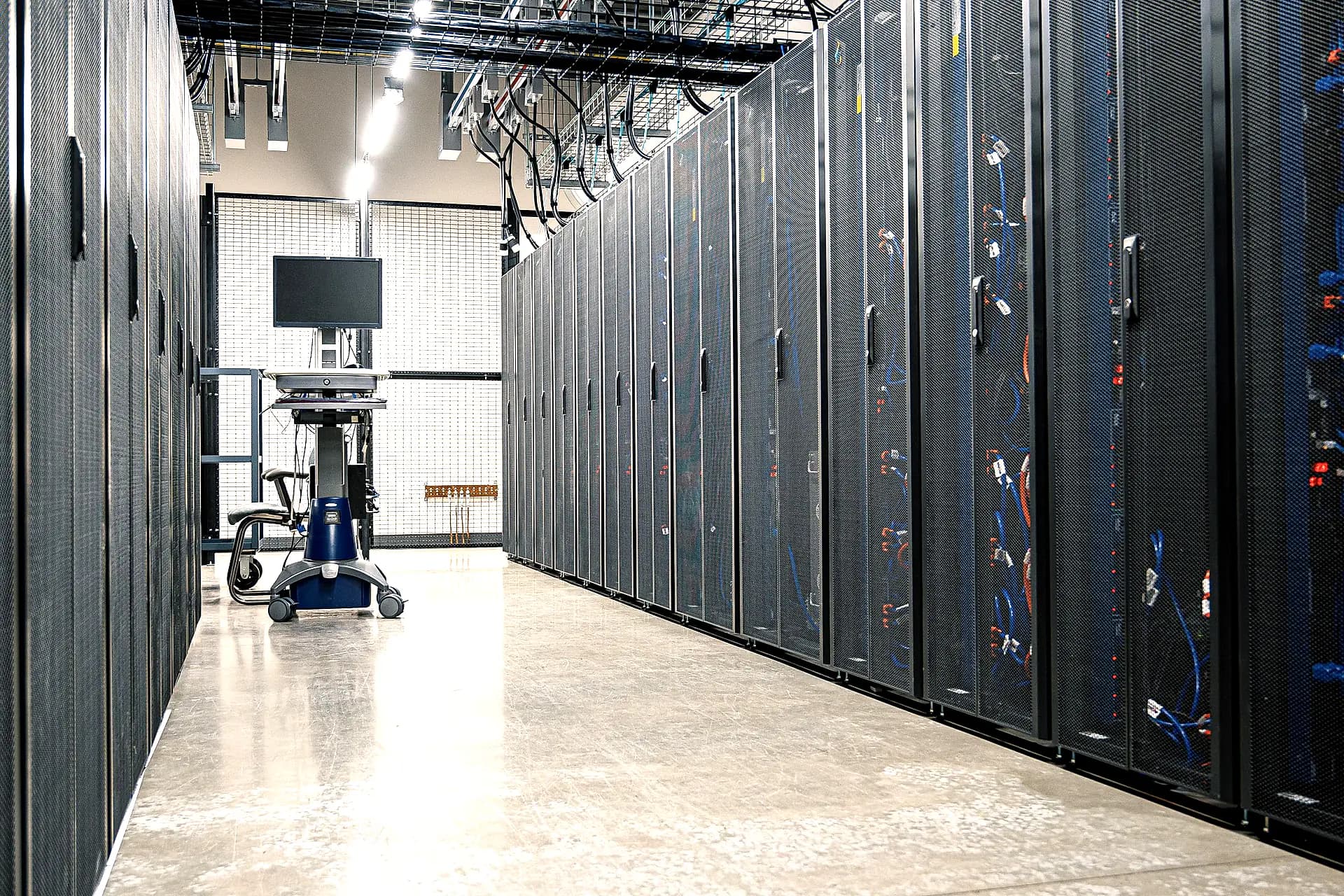 An aisle between server racks in a data centre